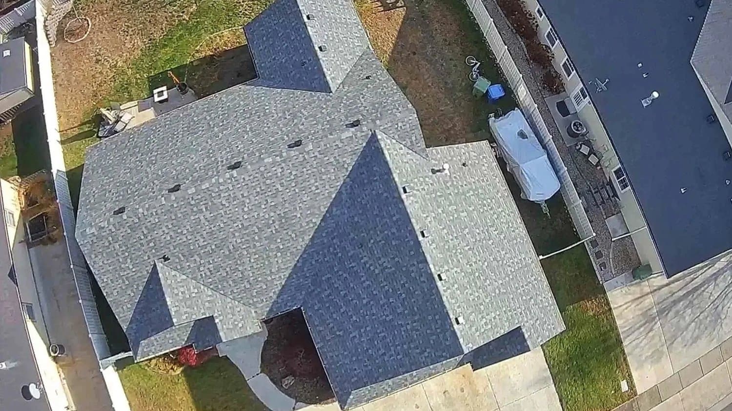 Aerial view of a completed residential roof with architectural shingles